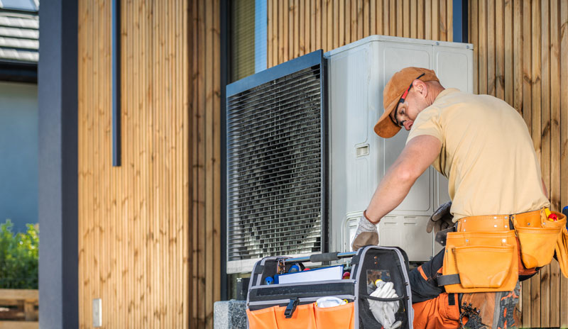 HVAC Technician working on a heat pump