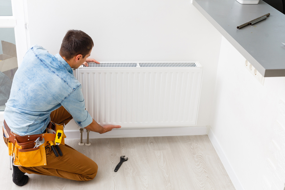 Man repairing an A/C unit.
